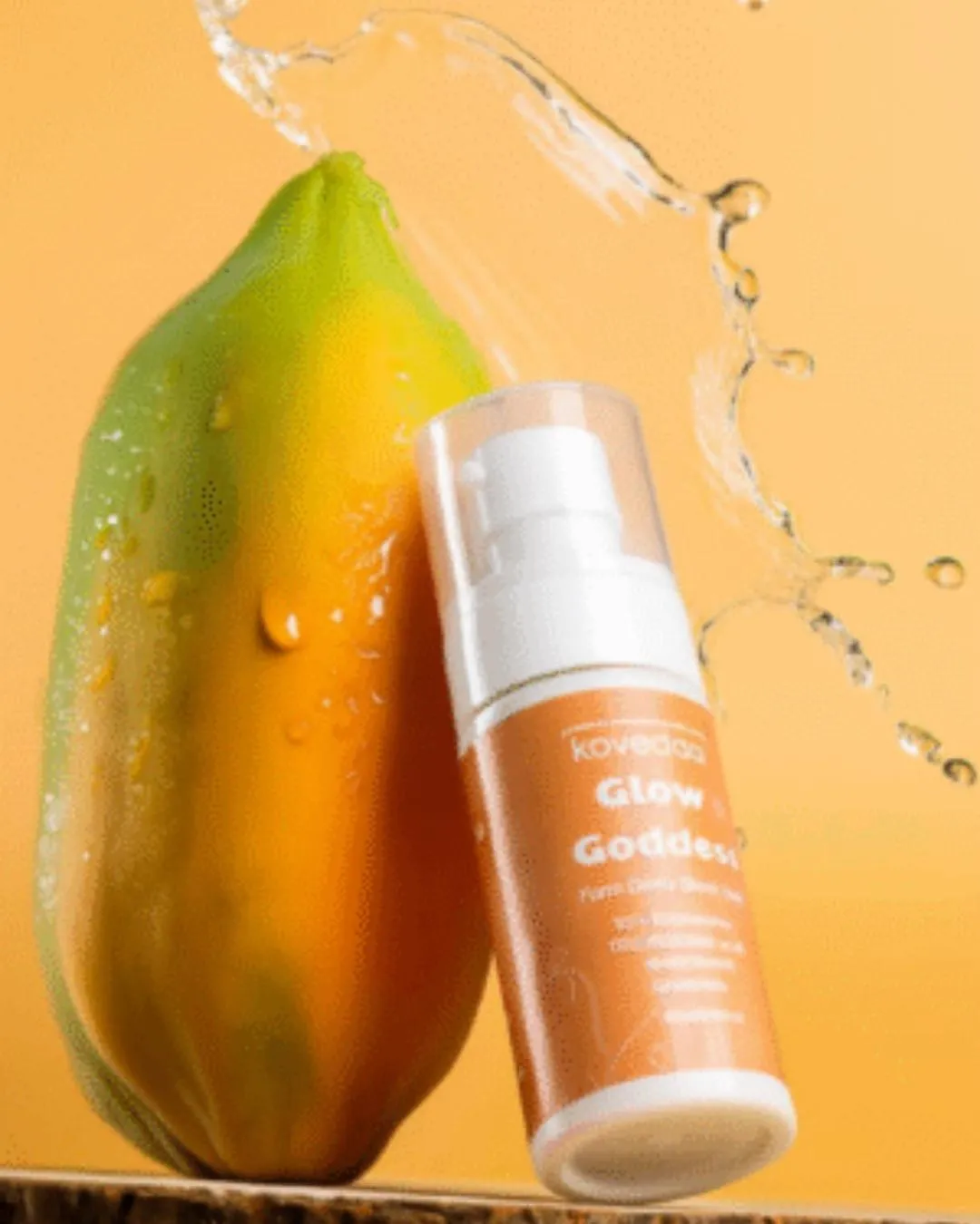 Commercial product shot of a serum bottle with papaya and a water splash, shot at Nearby Studio, Rajajinagar