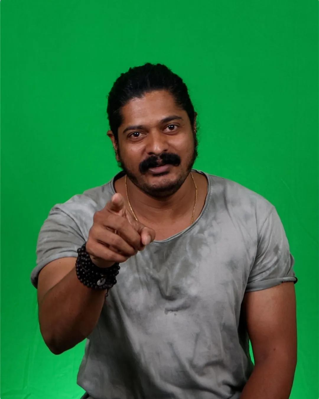 Man presenting to camera in front of an evenly lit green screen in Bengaluru