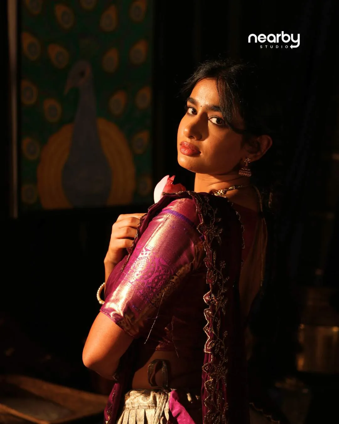 Dancer in a purple silk costume looking over her shoulder in an expressive portrait from a Navarasa series at Nearby Studio